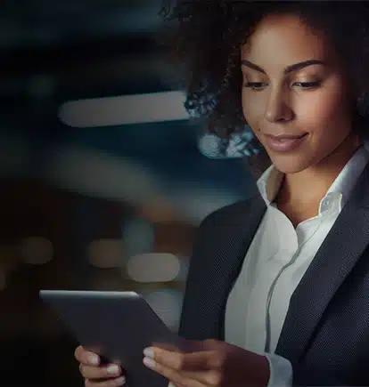 Woman using a tablet to access AI enabled QMS software